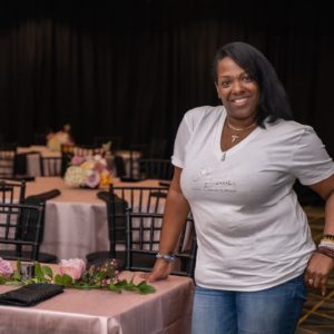 Virginia-based vendor poses in front of decorated table
