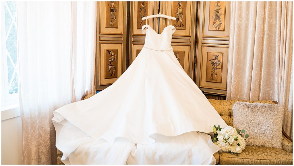 Wedding gown hangs up over couch in the Historic Mankin Mansion's bridal suite.