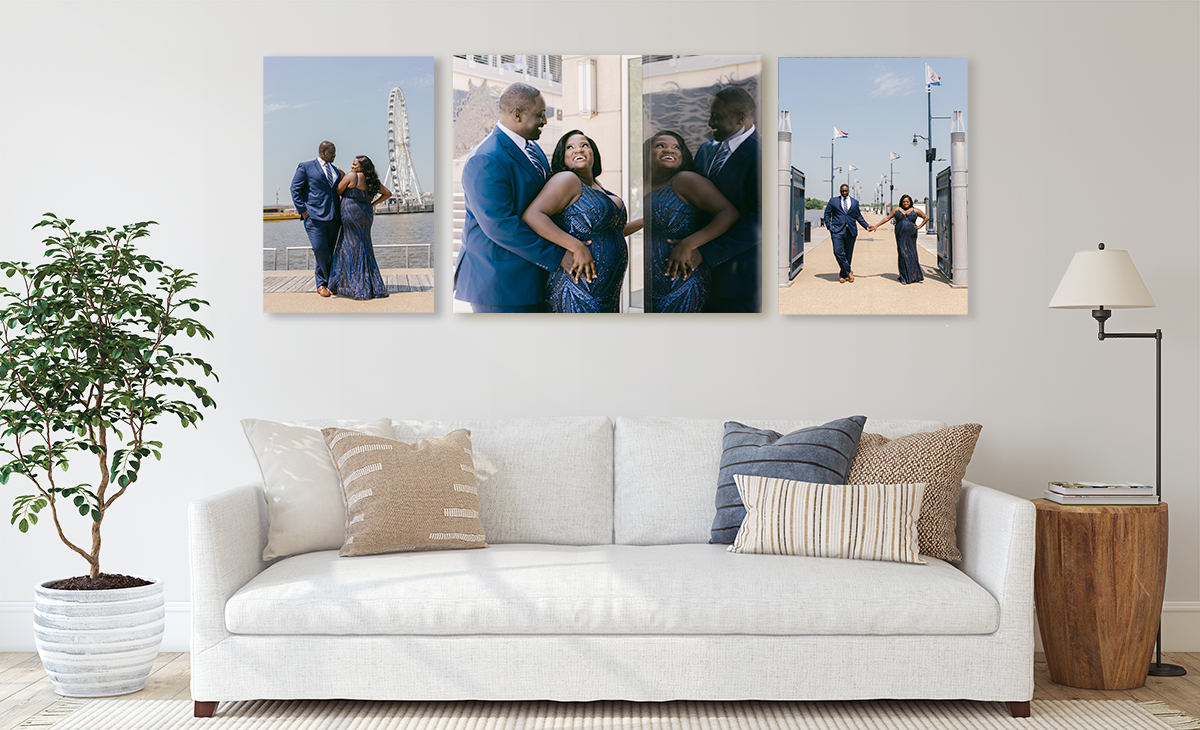 Engagement photos hang on wall above a white couch.